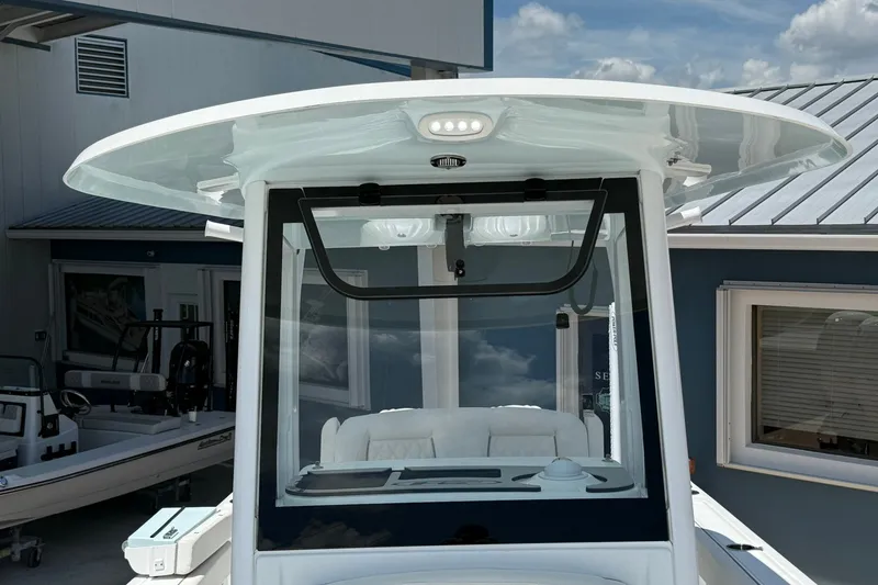 Slide: The Image of 2026 Sea Hunt Gamefish 25 boat console with T-top and modern design. - 34