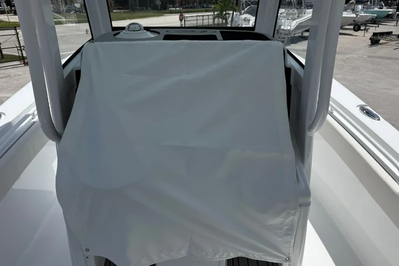 Slide: The Image of 2026 Sea Hunt Gamefish 25 boat console covered with protective fabric. - 16