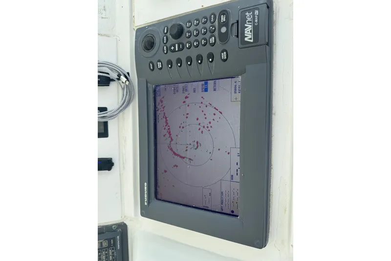 Slide: The Image of Radar display on 1994 Hatteras 54 Convertible boat, showing navigation data. - 13