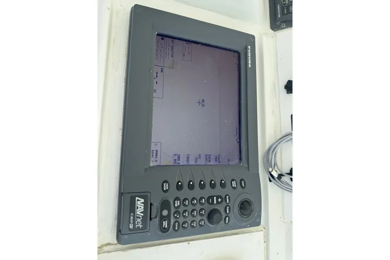 Slide: The Image of Navigation system on a 1994 Hatteras 54 Convertible boat, featuring a NAVnet C-Map NT display. - 14