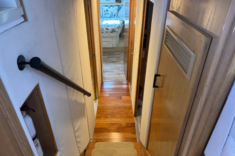 Slide: The Image of Interior hallway of 1994 Hatteras 54 Convertible yacht with wooden flooring and handrail. - 29