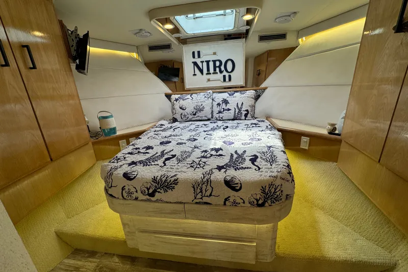 Slide: The Image of Luxurious cabin interior of 1994 Hatteras 54 Convertible yacht with nautical-themed bedding. - 21