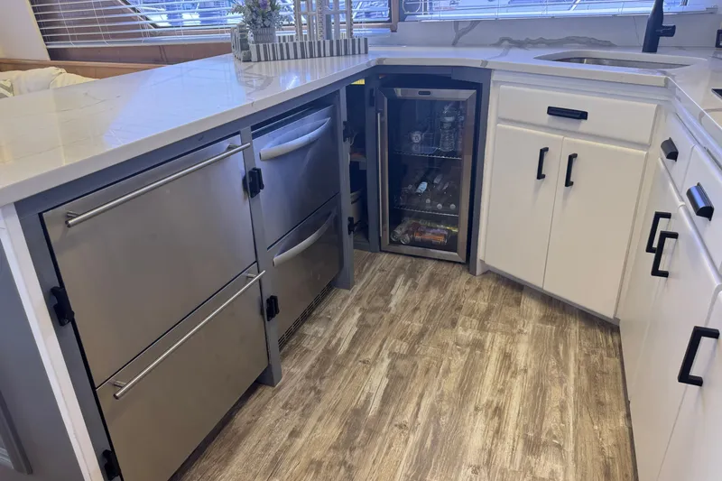 Slide: The Image of Modern kitchen area on a 1994 Hatteras 54 Convertible yacht with stainless steel appliances. - 30