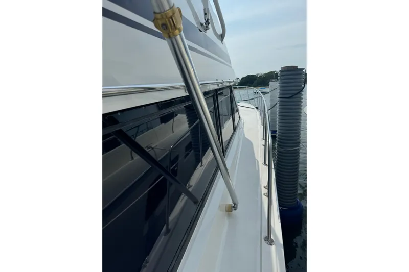 Slide: The Image of 1994 Hatteras 54 Convertible yacht side view with railing and dock. - 18