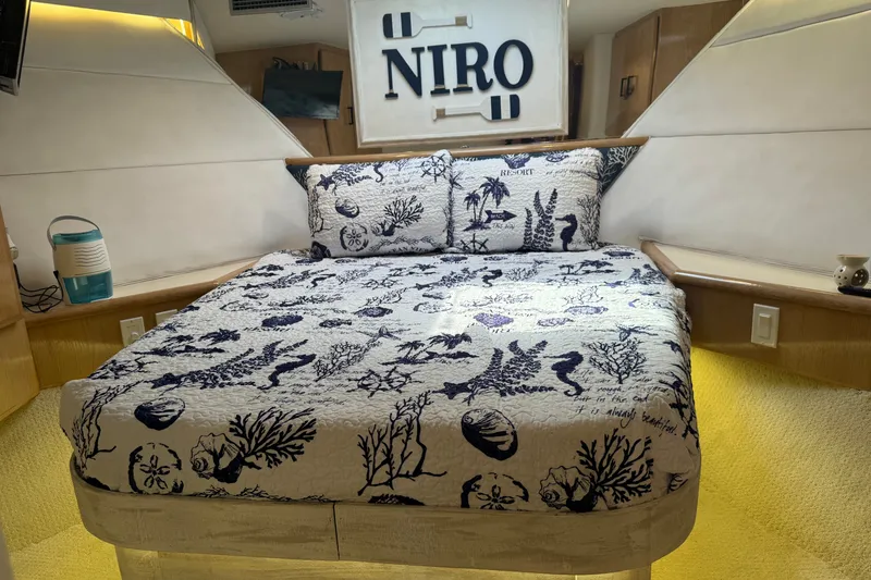 Slide: The Image of Cozy bedroom in 1994 Hatteras 54 Convertible yacht with nautical-themed bedding. - 20
