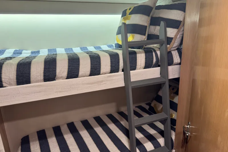 Slide: The Image of Bunk beds with striped bedding in a 1994 Hatteras 54 Convertible yacht cabin. - 22