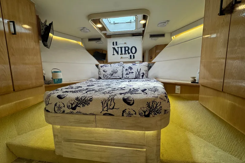 Slide: The Image of Luxurious cabin interior of 1994 Hatteras 54 Convertible yacht with nautical-themed bedding. - 19
