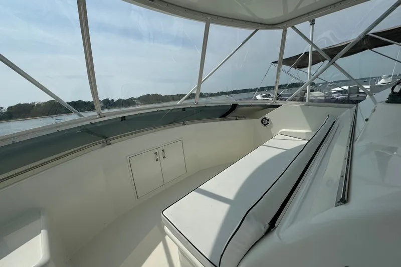 Slide: The Image of 1994 Hatteras 54 Convertible yacht interior with cushioned seating and storage. - 17