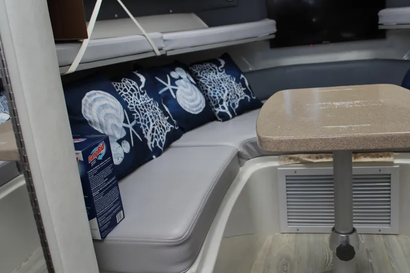 Slide: The Image of 2006 Pro-Line 32 Express cabin interior with cushioned seating and decorative pillows. - 38
