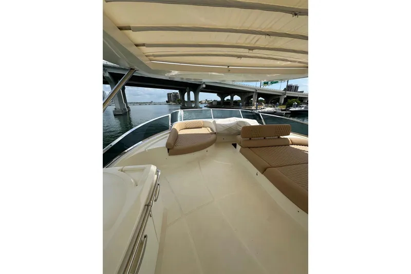 Slide: The Image of Luxurious 2010 Azimut 75 yacht deck with comfortable seating, under a bridge on calm waters. - 28