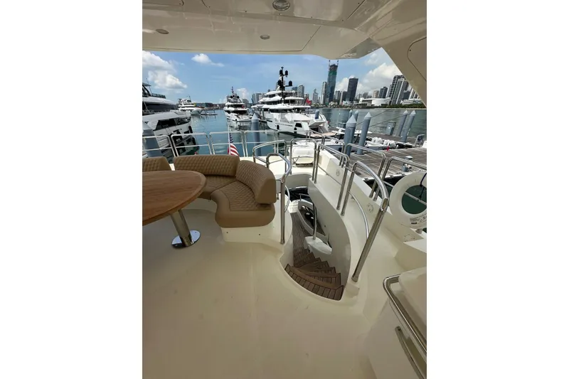 Slide: The Image of Luxurious 2010 Azimut 75 yacht interior with elegant seating, docked in a scenic marina. - 29