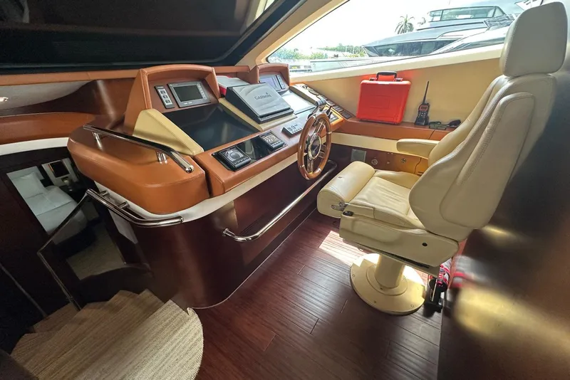 Slide: The Image of Pilot seat and control panel of a 2010 Azimut 75 yacht, featuring navigation equipment. - 31
