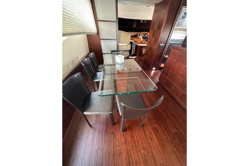 Slide: The Image of Luxurious dining area on a 2010 Azimut 75 yacht with glass table and leather chairs. - 16