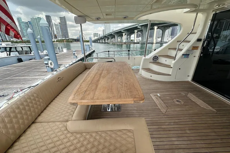 Slide: The Image of Luxurious 2010 Azimut 75 yacht deck with wooden table and city skyline view. - 4