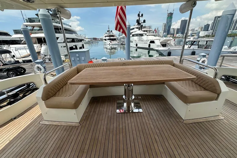 Slide: The Image of Luxury Azimut 75 yacht deck with elegant seating and table, docked at marina, 2010 model. - 2