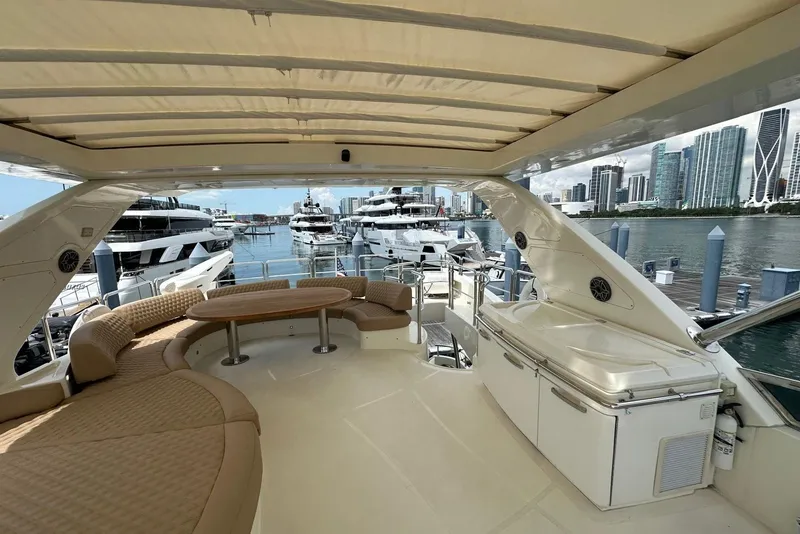 Slide: The Image of Luxurious 2010 Azimut 75 yacht deck with seating, table, and city skyline view. - 22