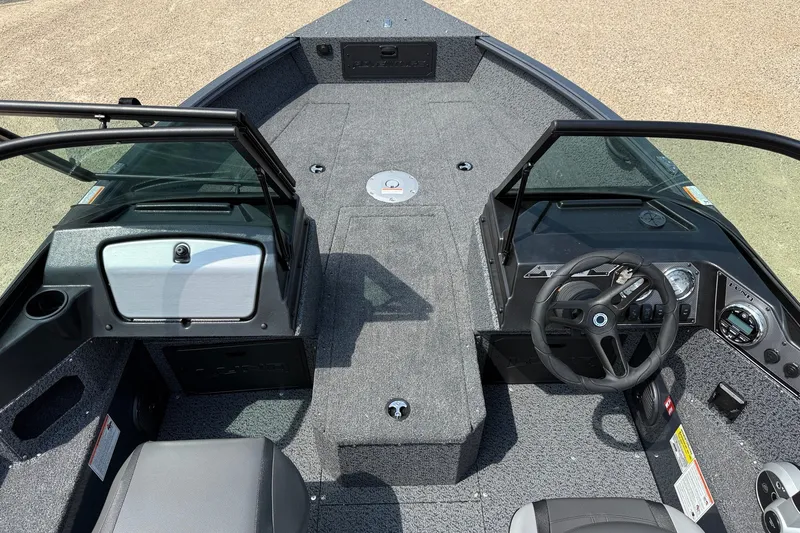 Slide: The Image of Interior view of 2027 Lund 1700 Adventure Sport boat, featuring steering wheel and seating. - 3