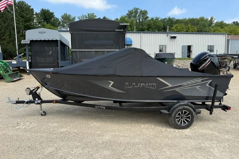 Slide: The Image of 2027 Lund 1700 Adventure Sport boat with cover on trailer, parked outdoors. - 15