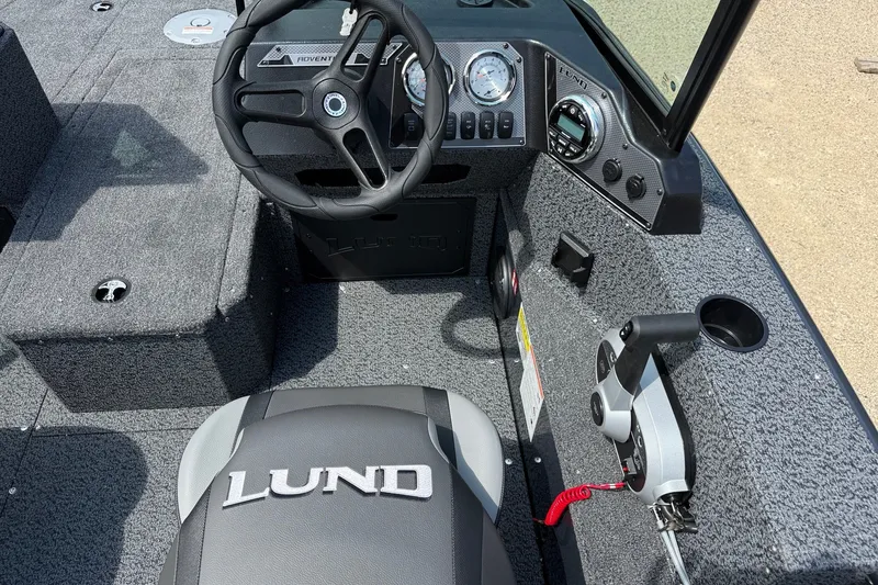 Slide: The Image of Interior of 2027 Lund 1700 Adventure Sport boat with steering wheel and dashboard controls. - 8