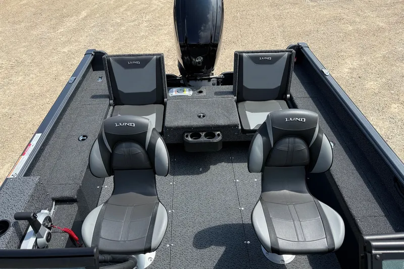 Slide: The Image of 2027 Lund 1700 Adventure Sport boat interior with four gray seats and motor. - 7