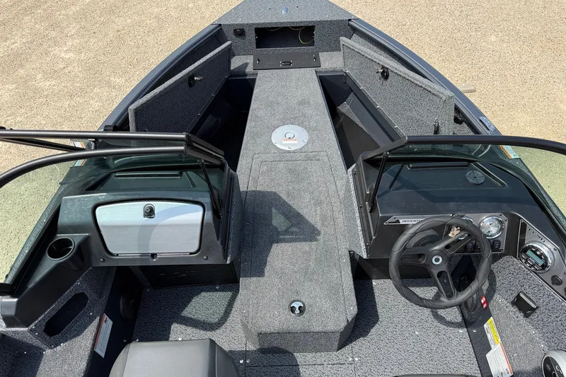 Slide: The Image of 2027 Lund 1700 Adventure Sport boat interior with steering wheel and storage compartments. - 4