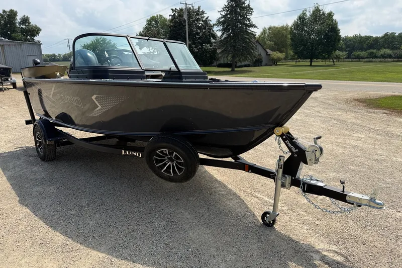 Slide: The Image of 2027 Lund 1700 Adventure Sport boat on trailer, parked outdoors. - 2