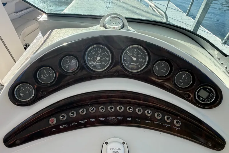 Slide: The Image of Dashboard of a 2006 Crownline 290 CR boat with gauges and controls. - 15