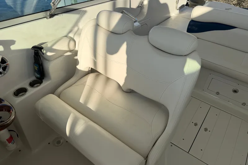 Slide: The Image of 2006 Crownline 290 CR boat interior with white leather seating and cup holders. - 13