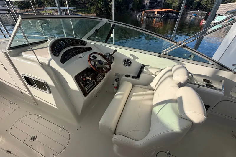 Slide: The Image of 2006 Crownline 290 CR boat cockpit with steering wheel and control panel. - 12