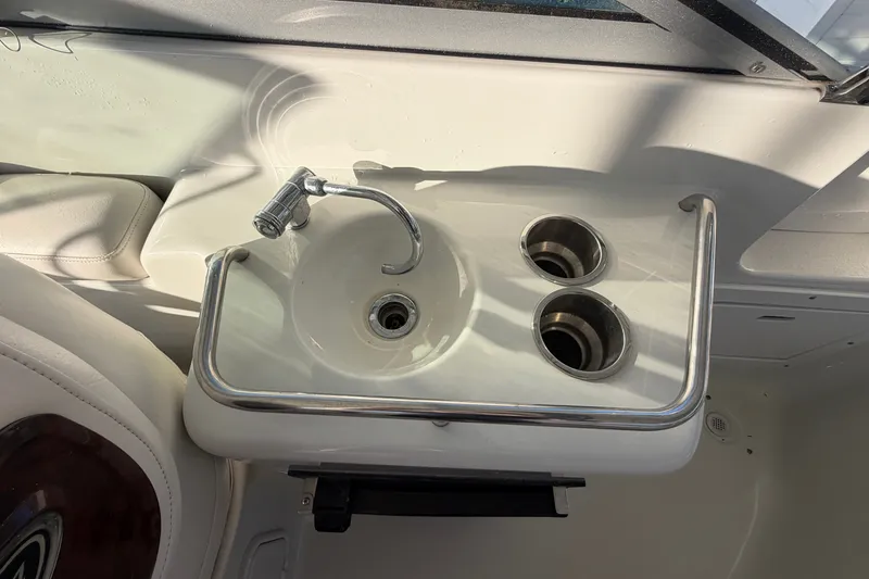 Slide: The Image of 2006 Crownline 290 CR boat sink with faucet and cup holders. - 11