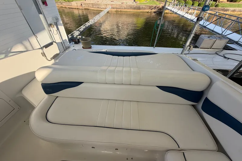 Slide: The Image of 2006 Crownline 290 CR boat interior with cushioned seating by the water. - 9