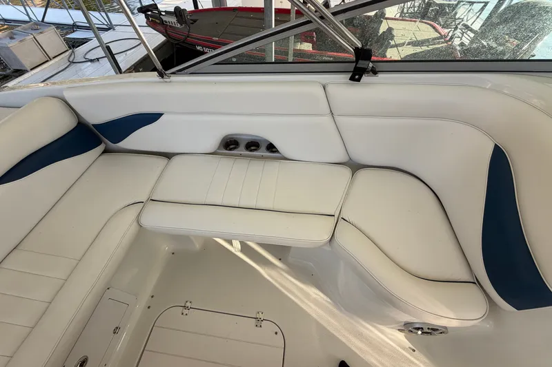 Slide: The Image of 2006 Crownline 290 CR boat interior with white and blue seating arrangement. - 8