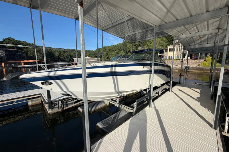 Slide: The Image of 2006 Crownline 290 CR boat docked under a covered marina. - 2