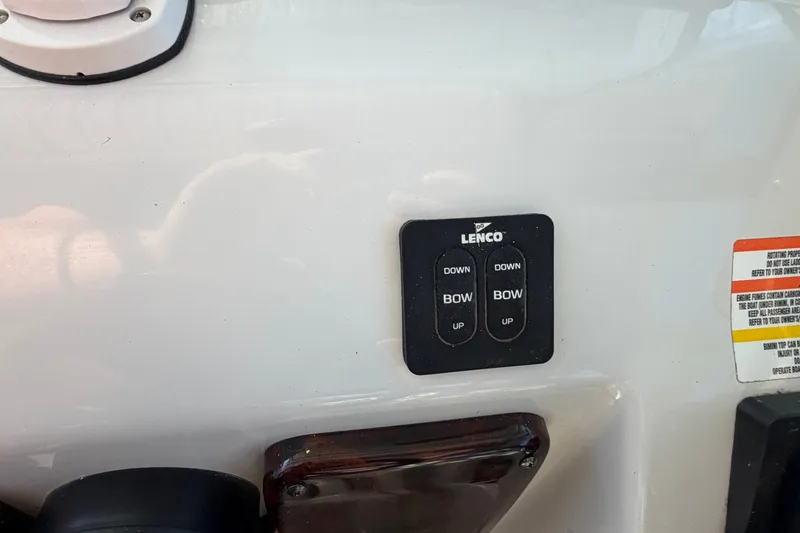 Slide: The Image of Lenco trim tab controls on a 2006 Crownline 290 CR boat dashboard. - 17