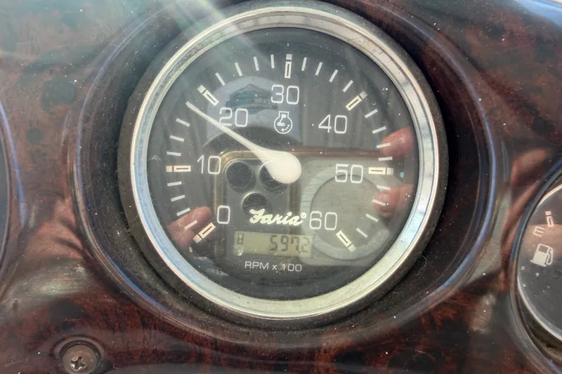Slide: The Image of Tachometer of a 2006 Crownline 290 CR boat showing RPM and hours. - 27
