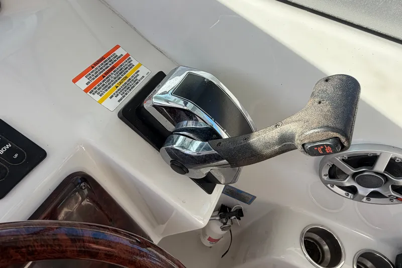 Slide: The Image of Throttle control on a 2006 Crownline 290 CR boat dashboard. - 16