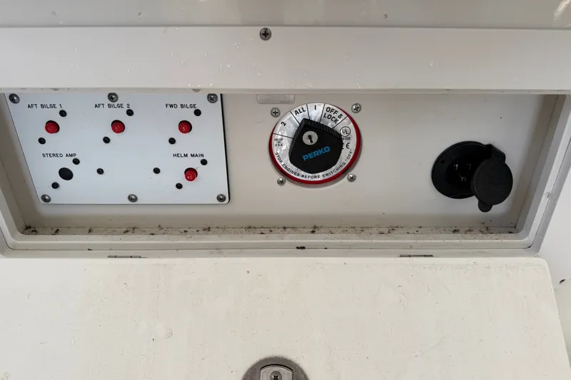 Slide: The Image of Control panel of a 2006 Crownline 290 CR boat with switches and a Perko dial. - 31