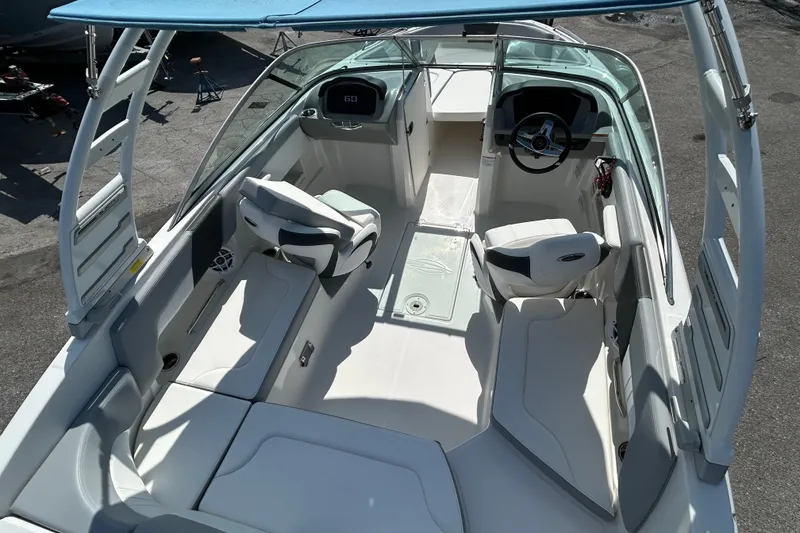 Slide: The Image of 2025 Chaparral 23 SSi OB boat interior with seating and steering wheel. - 10