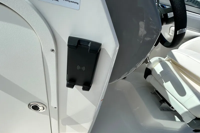 Slide: The Image of Interior of 2025 Chaparral 23 SSi OB boat with steering wheel and phone holder. - 15