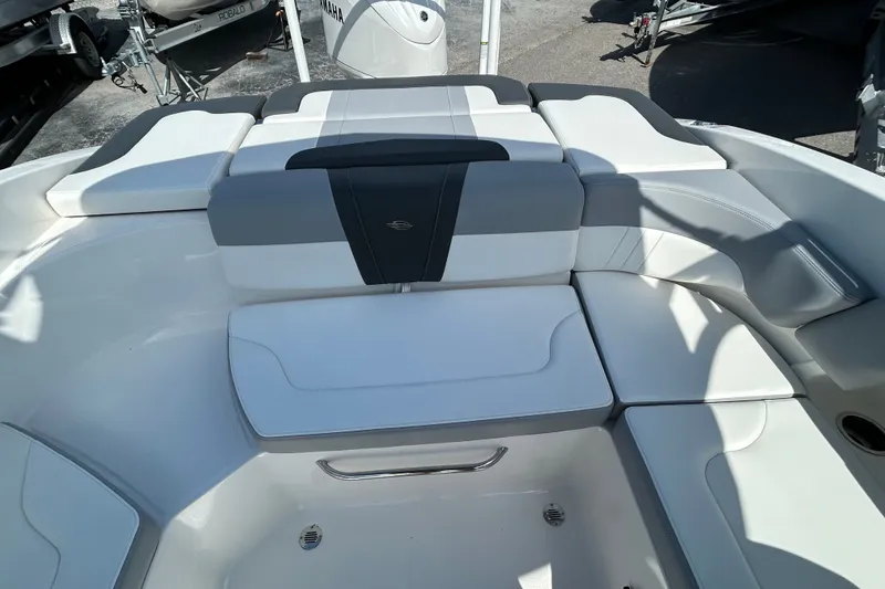 Slide: The Image of 2025 Chaparral 23 SSi OB boat interior with cushioned seating and sleek design. - 17