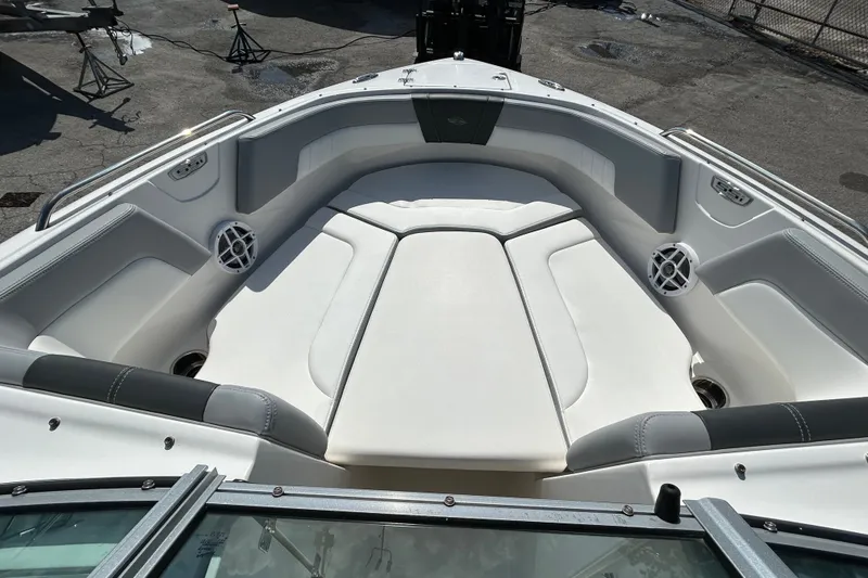 Slide: The Image of 2025 Chaparral 23 SSi OB boat interior with white seating and speakers. - 13