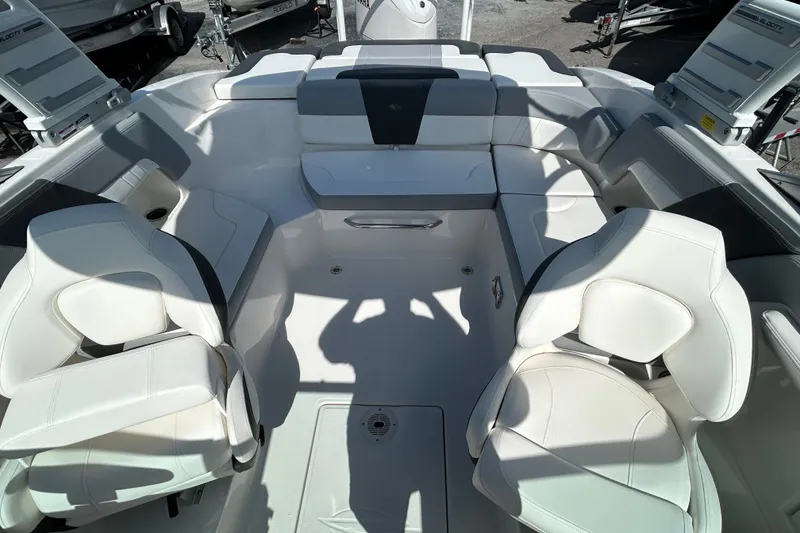 Slide: The Image of 2025 Chaparral 23 SSi OB boat interior with white seating and modern design. - 16