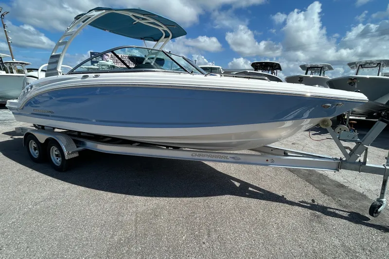 Slide: The Image of 2025 Chaparral 23 SSi OB boat on trailer under blue sky. - 8