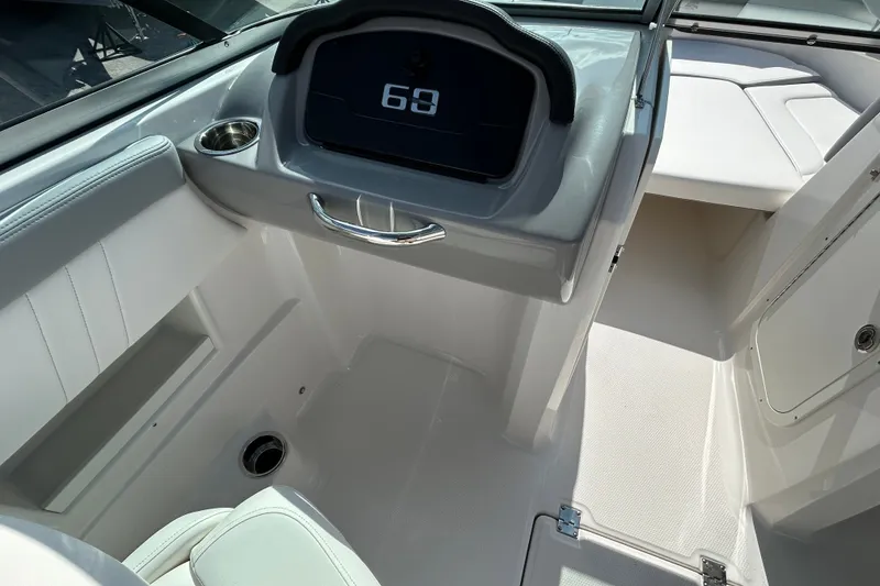 Slide: The Image of Interior view of 2025 Chaparral 23 SSi OB boat, featuring sleek dashboard and seating. - 14