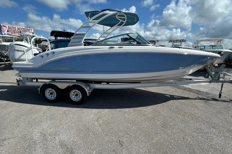 Slide: The Image of 2025 Chaparral 23 SSi OB boat on trailer under blue sky. - 7