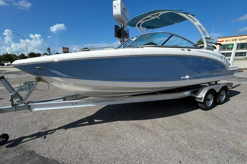 Slide: The Image of 2025 Chaparral 23 SSi OB boat on trailer, blue hull, sunny day. - 3