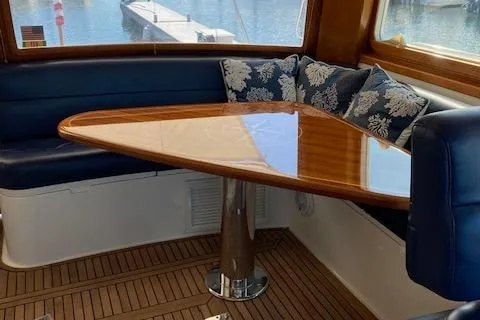 Slide: The Image of Luxurious 2001 Grand Banks 49 Eastbay SX yacht interior with elegant wooden table and plush seating. - 13