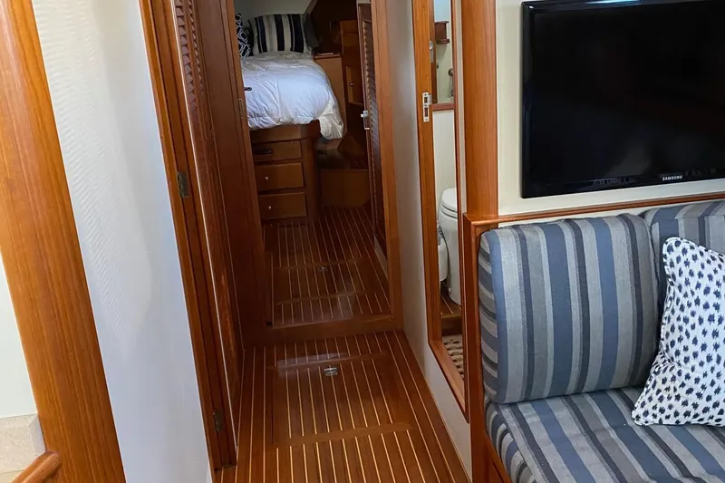 Slide: The Image of Interior of 2001 Grand Banks 49 Eastbay SX with wood flooring and striped seating. - 15