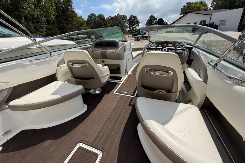Slide: The Image of Interior of a 2007 Cobalt 250 boat with white seating and wood flooring. - 20