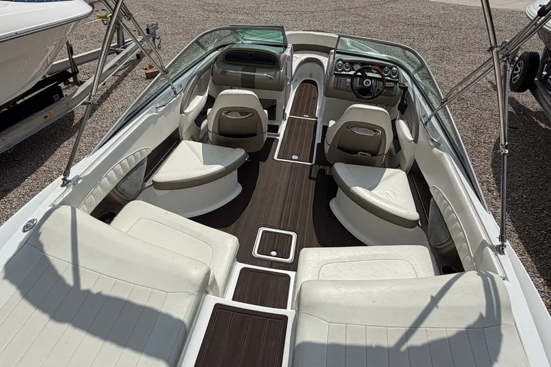 Slide: The Image of 2007 Cobalt 250 boat interior with white seating and wood accents. - 21